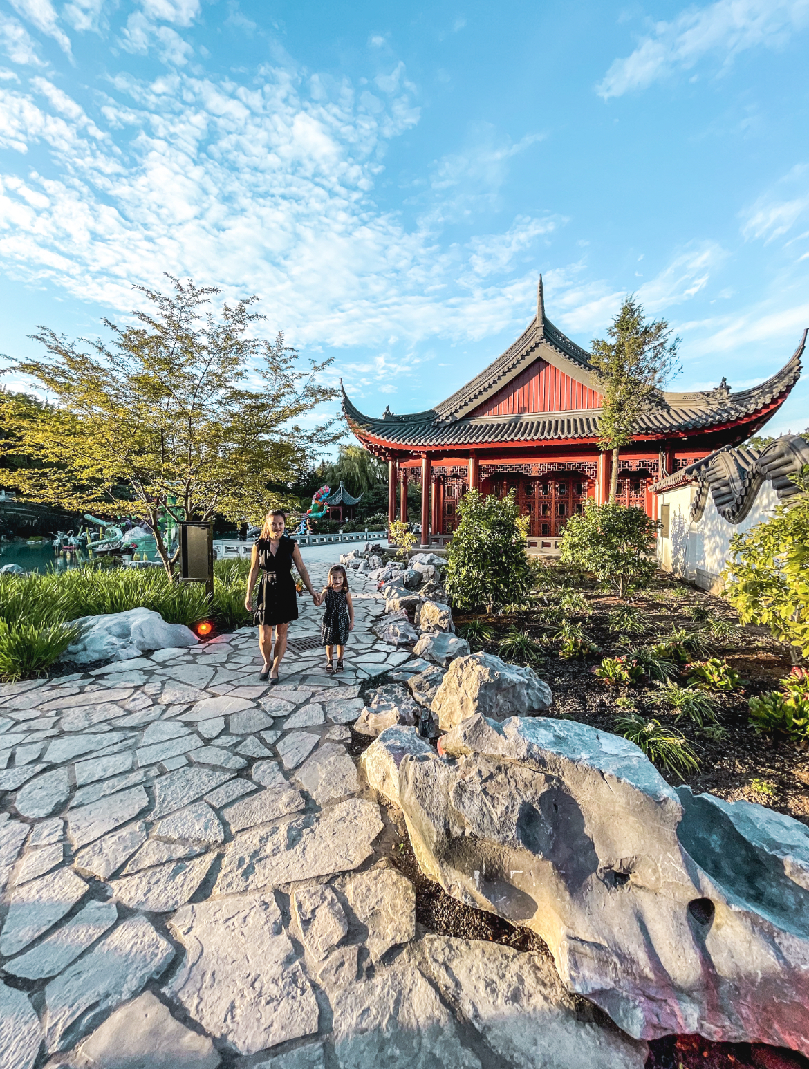 mom and daughter walking in Chinese garden montreal