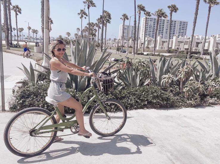 roung lady bicycling at Santa Monica beach